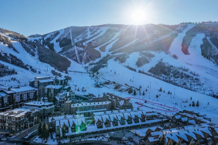 Expansive ski terrain surrounding a village with multiple buildings