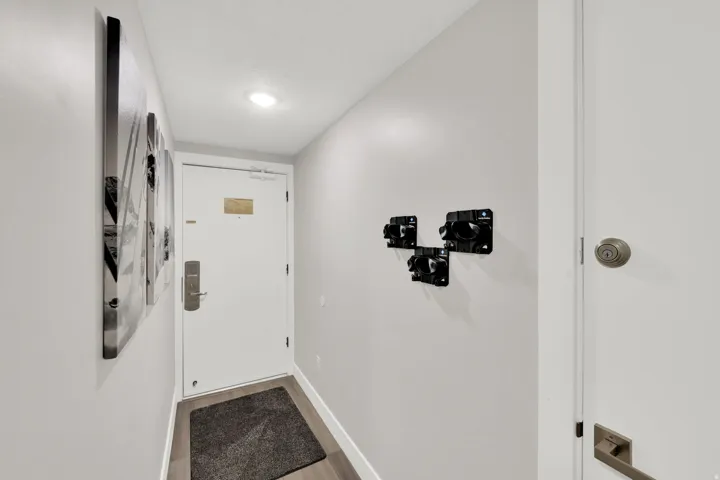 Recessed ceiling lighting, wood-finish flooring, white doors, and painted walls