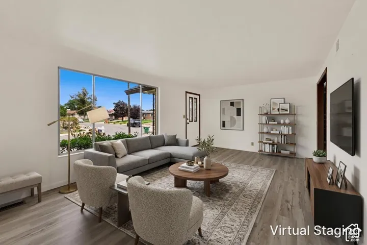 STAGED Spacious interior featuring New LVP  wood-finish flooring, a large multi-pane window, and Fresh paint.