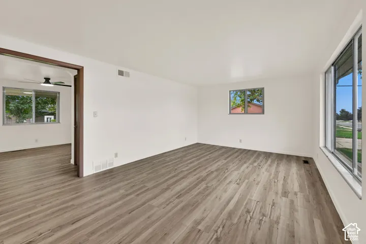 Spacious interior with New LVP wood-finish flooring, fresh paint white walls, and large windows