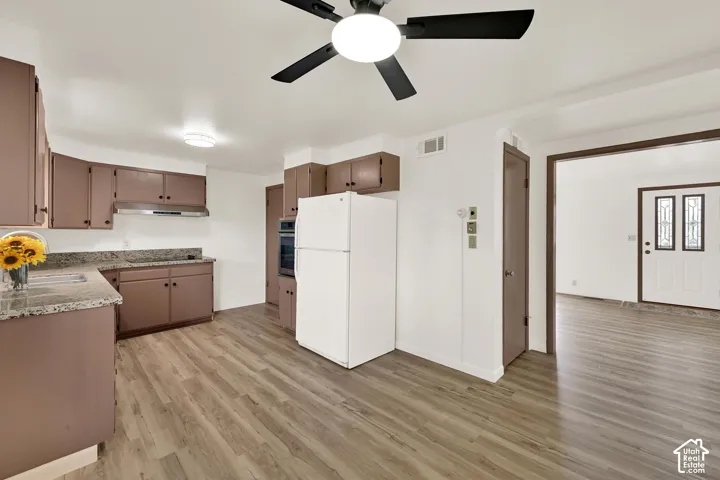 Kitchen featuring New LVP wood-finish flooring, recessed lighting, and a New ceiling fan. Fresh paint