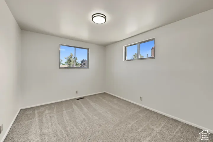 Light gray wall paint complemented by matching gray carpeting