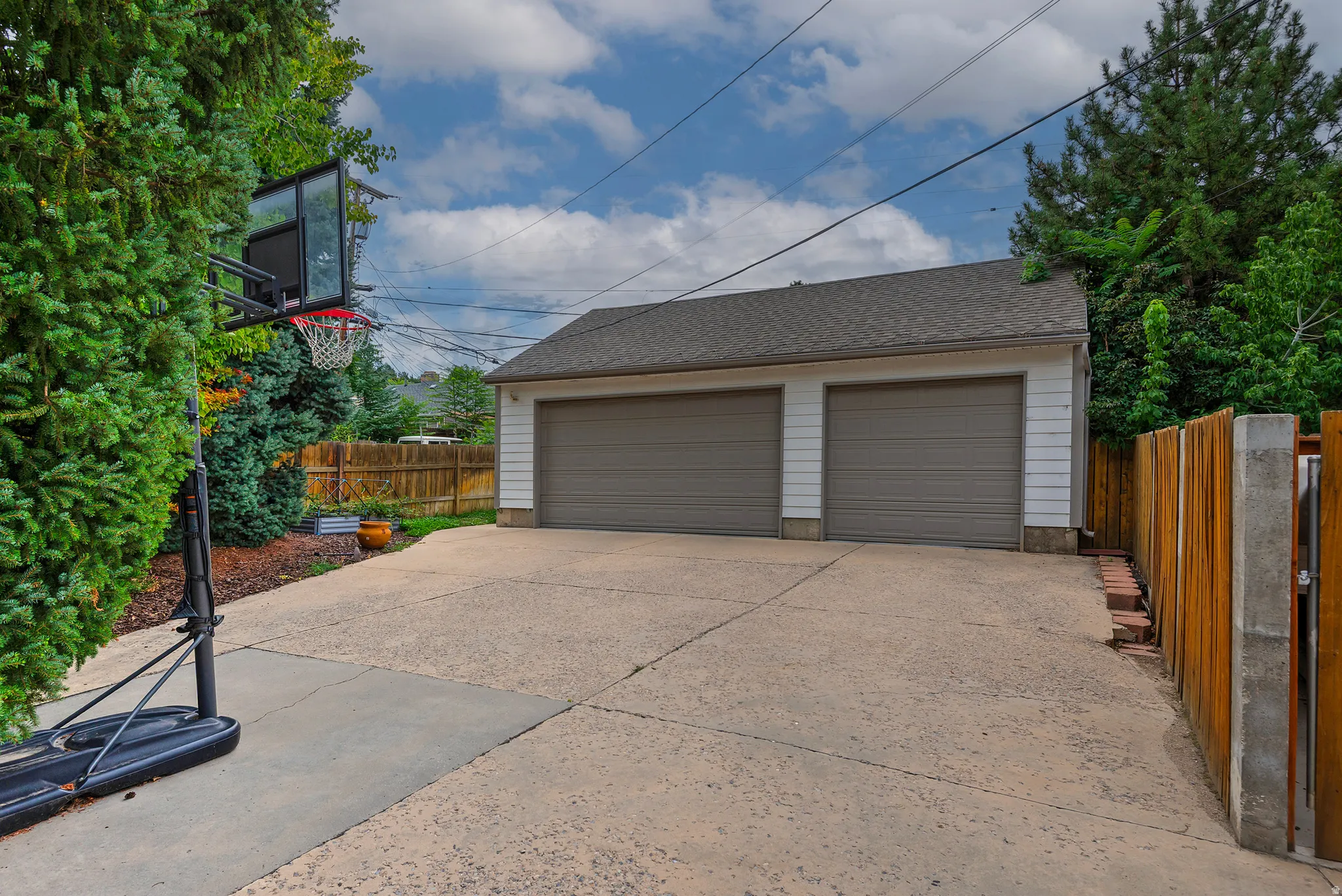Two-car detached garage with panel doors and a shingle roof