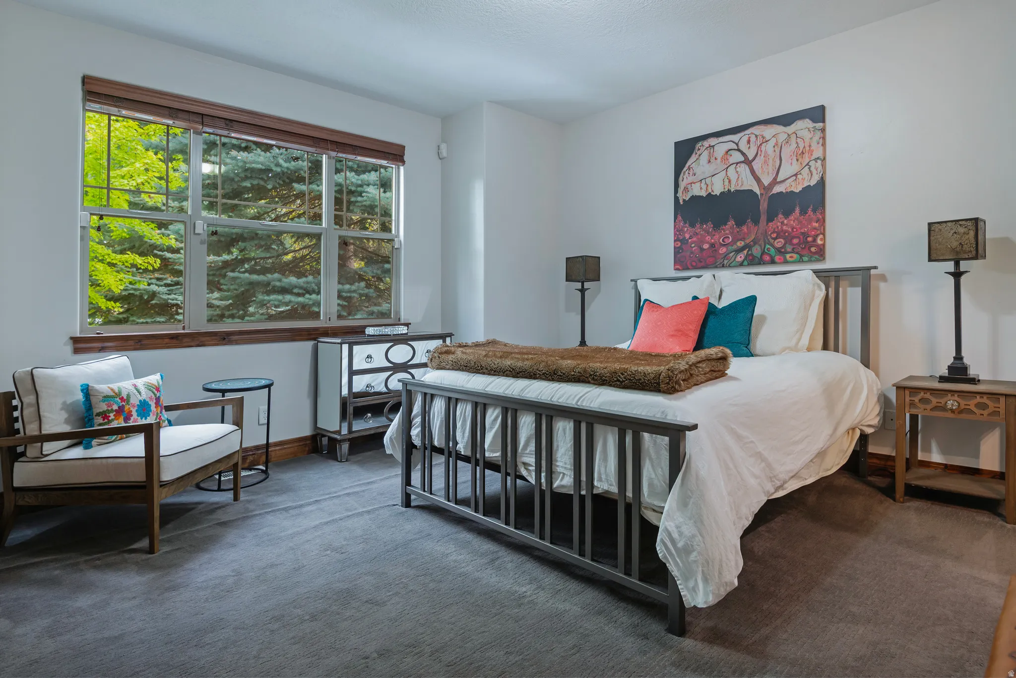 Expansive window with wood trim, gray carpet flooring, and white walls