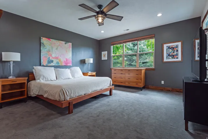 Recessed lighting, ceiling fan with light fixture, wood-trimmed window, wood-finish baseboards, and wall-to-wall carpeting