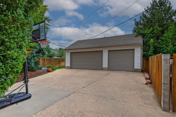 Two-car detached garage with panel doors and a shingle roof