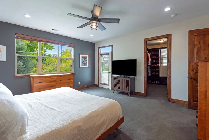 Recessed lighting, ceiling fan, carpeting, wood-frame windows, and wood trim detailing