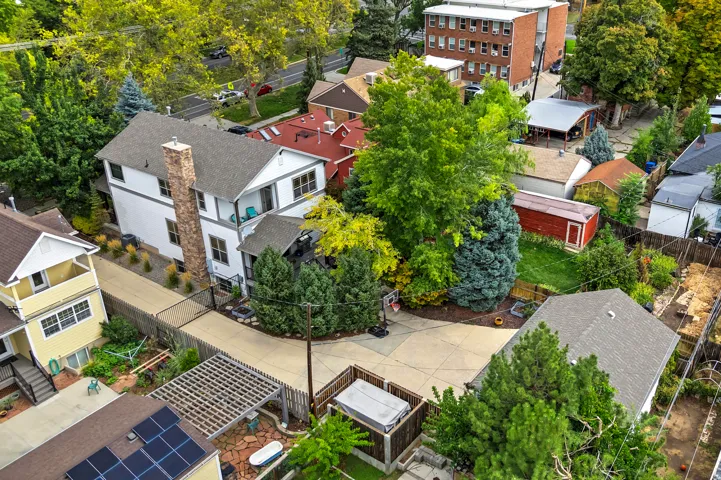 Exterior featuring a stone chimney, gray shingle roof, and a private balcony