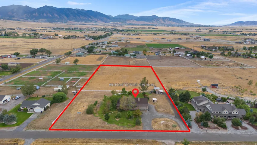Expansive property with a defined boundary, a single-story residence, and a long driveway