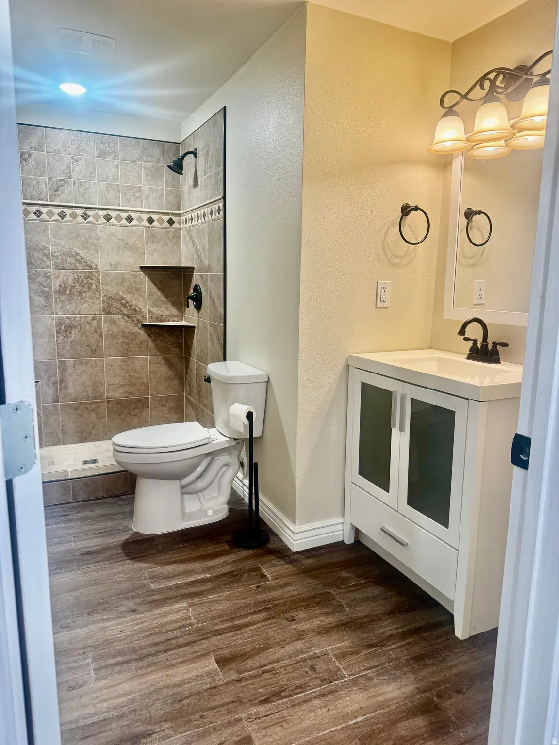 Walk-in shower with tiled surround and decorative accent band