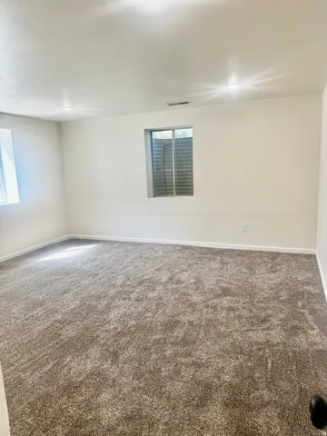 Wall-to-wall carpet flooring, recessed lighting, and neutral wall tones