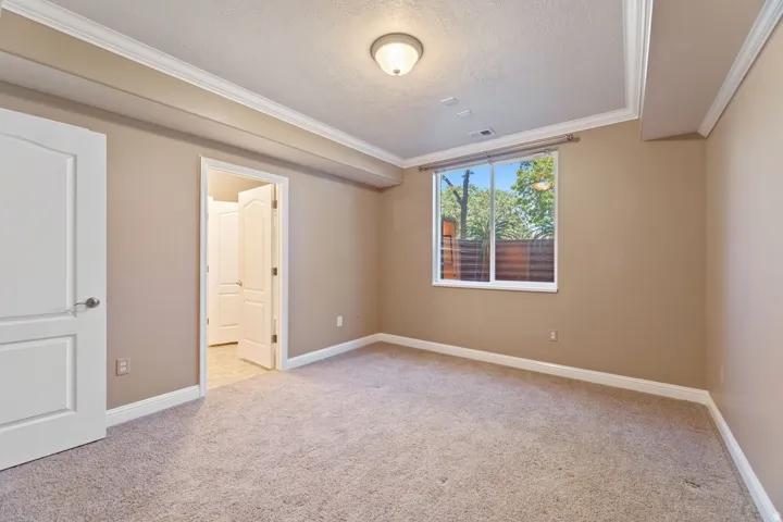 Neutral-toned walls complement plush carpeting