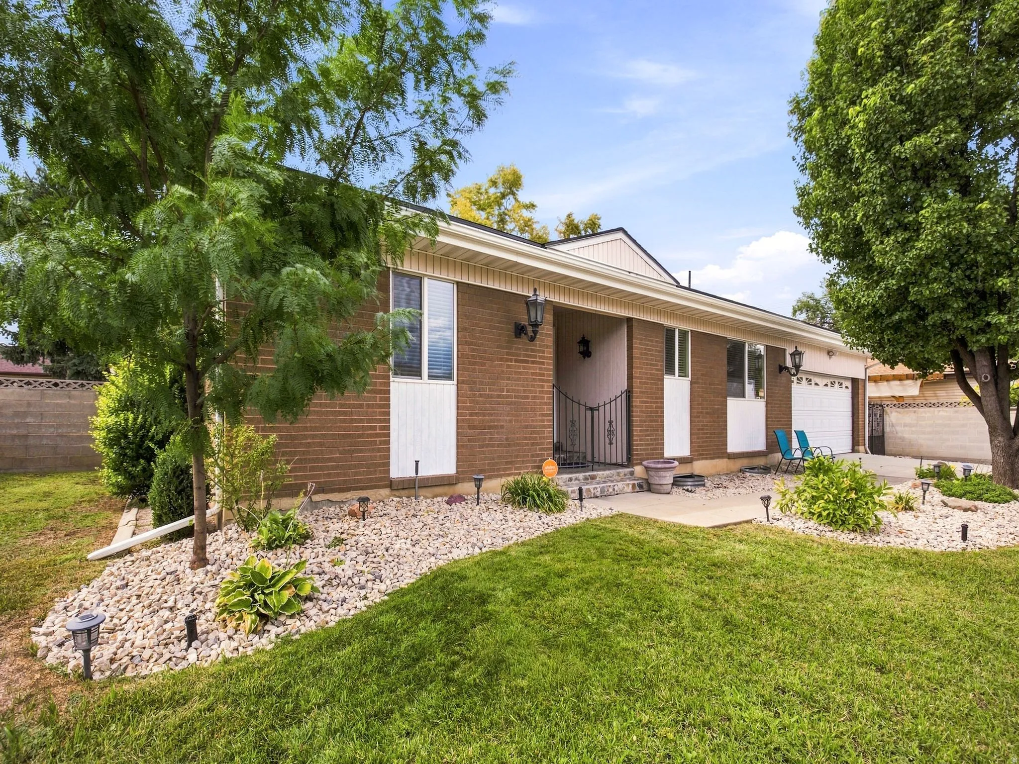Brick exterior with a covered entry and an attached garage