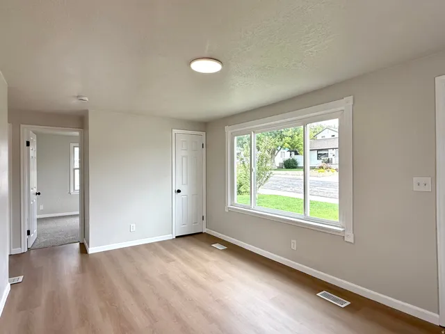 Light wood-finish flooring complemented by neutral wall tones