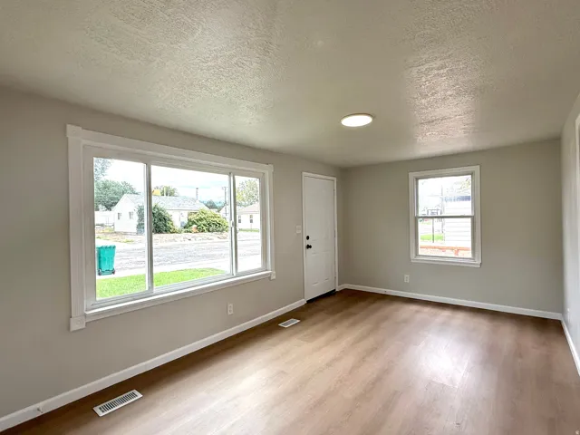 Wood-finish flooring, recessed ceiling light, white trim, and light gray wall paint