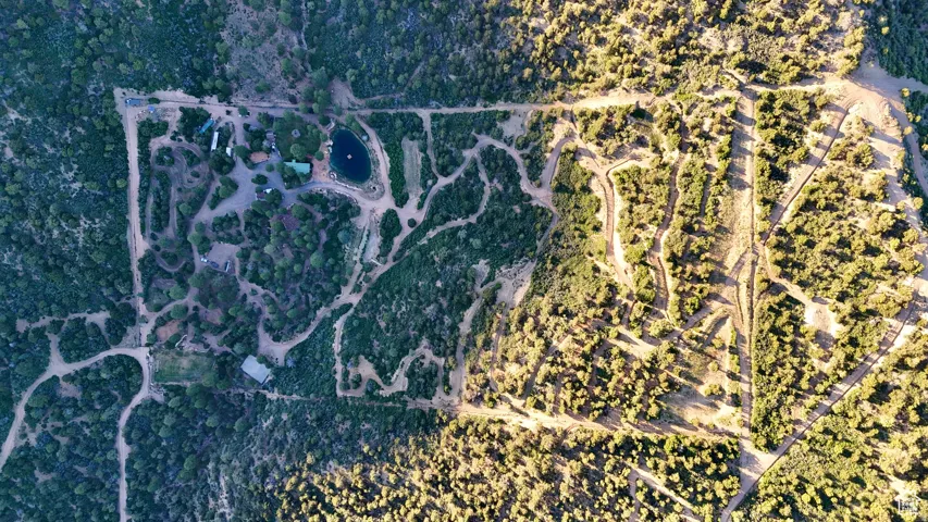 Aerial View. Displaying the property's boundaries, structures, and surrounding terrain
