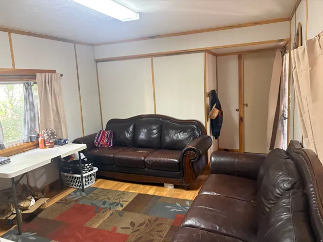Wood-finish flooring with white wall panels and wood trim