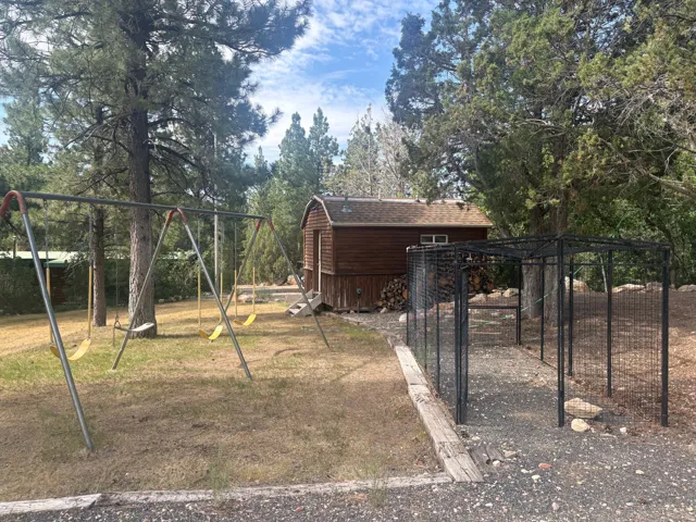 Wood-sided outbuilding with an asphalt shingle roof