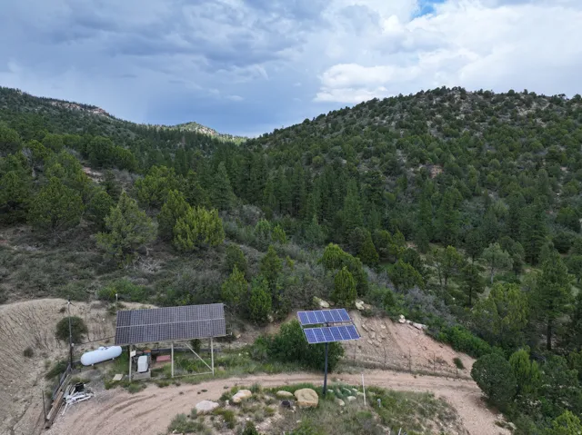 Expansive forested hillsides with integrated solar panel arrays