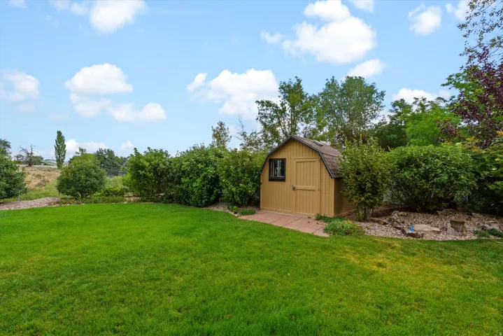 Shed built above a concrete pad stores the essentials.