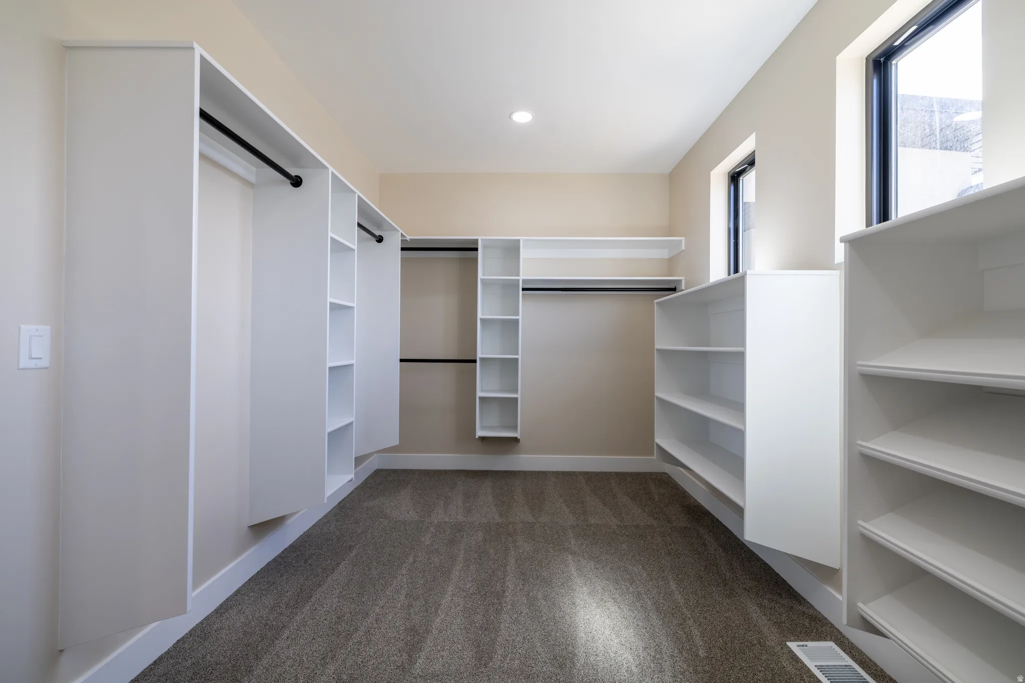 Built-in closet organization system with shelving and hanging rods