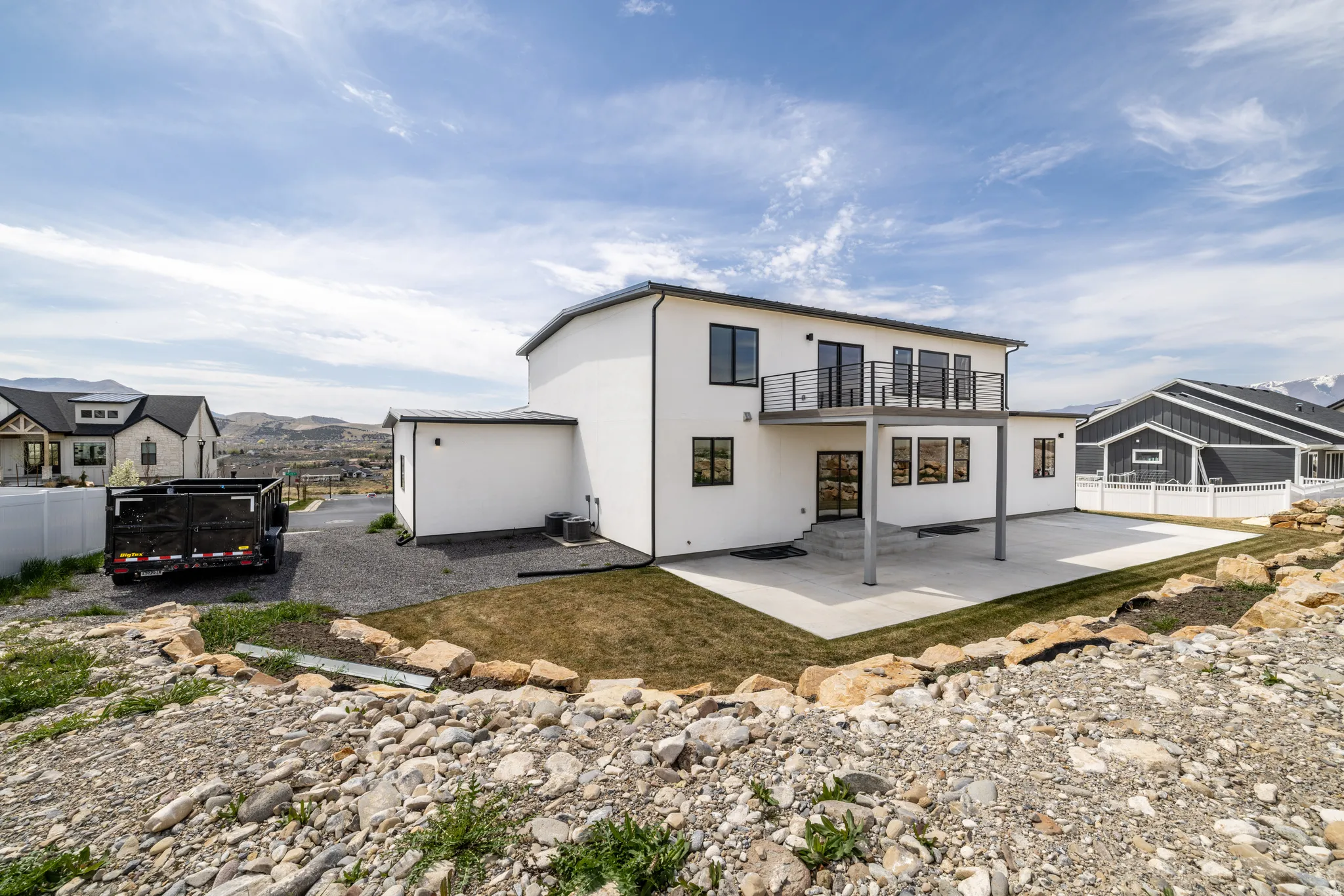 Modern exterior with white stucco siding and black-framed windows