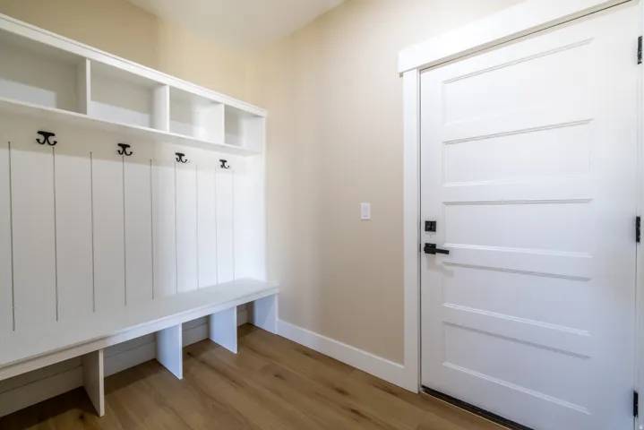 Built-in mudroom bench with cubbies, upper shelving, and coat hooks