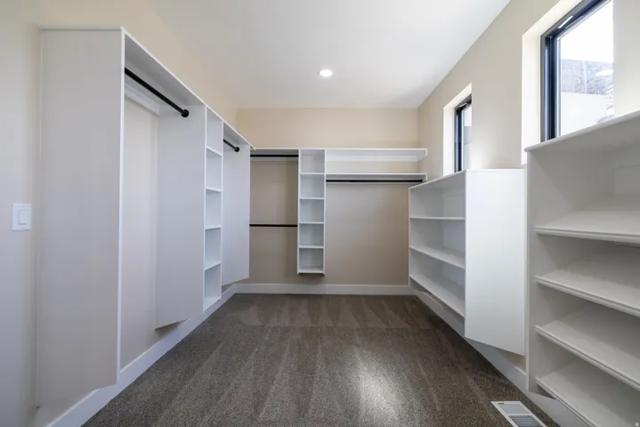 Built-in closet organization system with shelving and hanging rods
