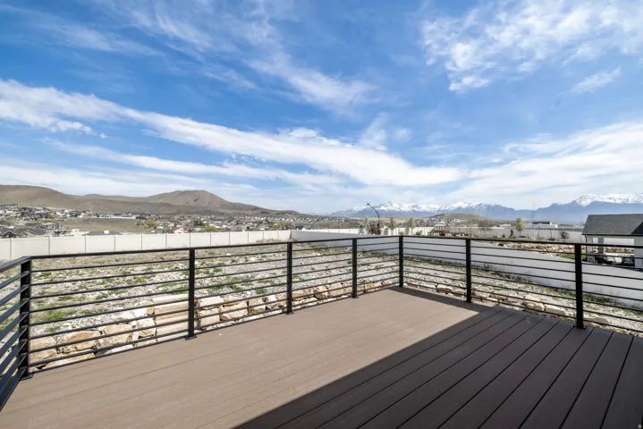 Expansive outdoor deck with composite wood-finish flooring and modern horizontal metal railings