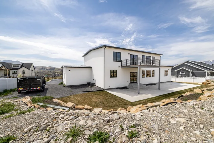 Modern exterior with white stucco siding and black-framed windows