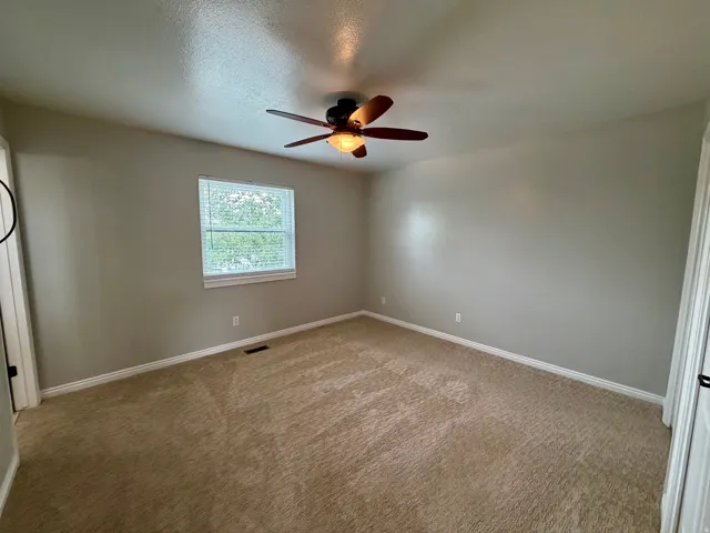 Neutral-toned walls complement the carpeted flooring