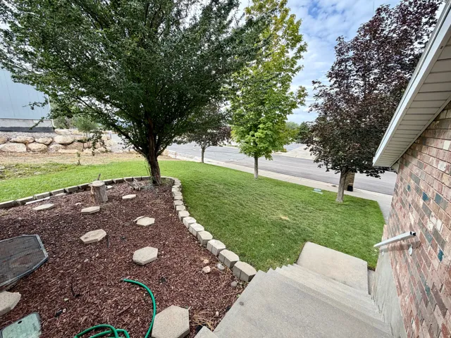 Brick exterior with white soffit, concrete steps, and a metal handrail