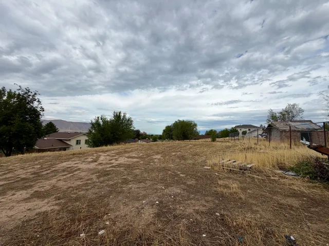 Expansive open lot featuring distant mountain scenery