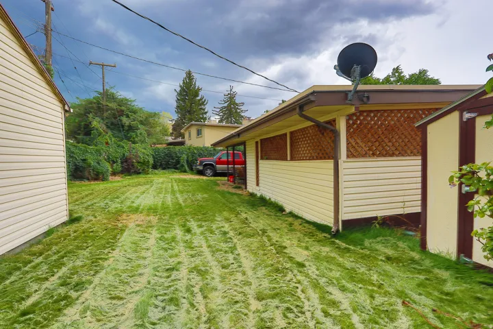 Expansive lawn area with mature perimeter landscaping