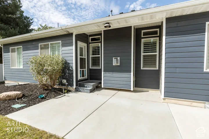 Concrete patio with blue siding and white trim