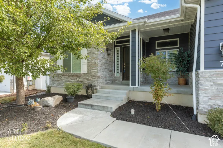 Exterior featuring stone veneer and horizontal siding