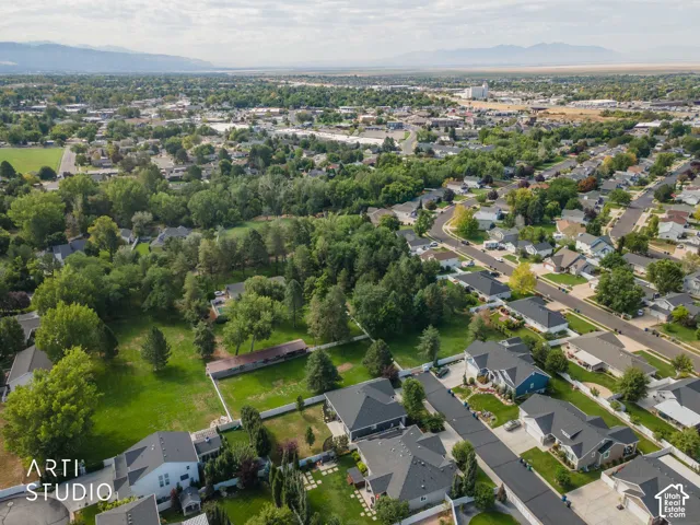 Expansive green spaces within a residential area featuring mature trees and established homes