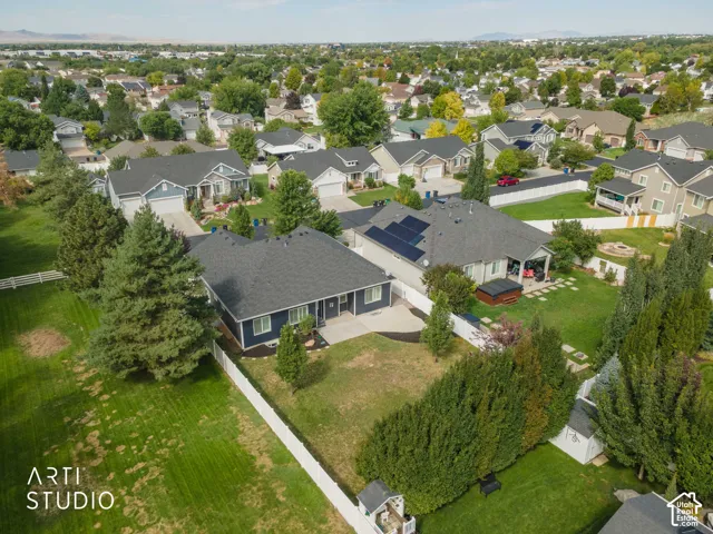 Expansive property with a white perimeter fence, mature trees, and a detached storage shed