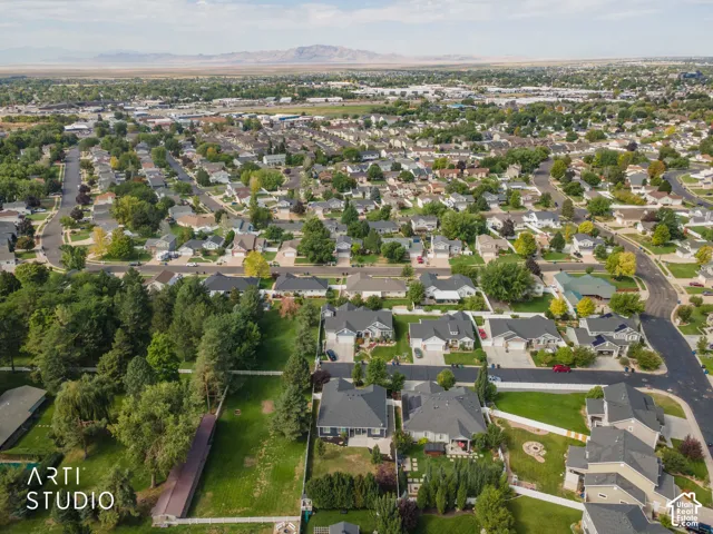 Residential neighborhood featuring mature trees and mountain scenery