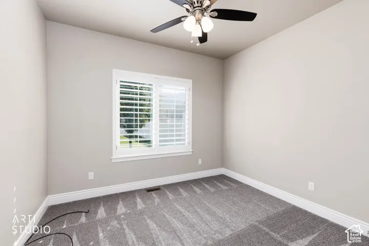 Neutral painted walls and grey patterned carpeting