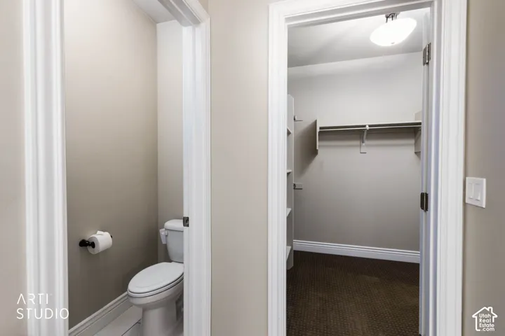 Powder room with a white toilet and white floor tiles