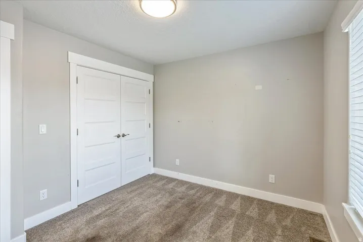 Neutral-toned walls complement the textured carpeting