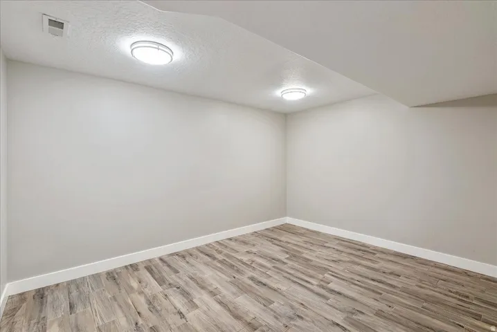 Recessed lighting, tile-finish flooring, white walls, and bright white trim