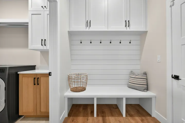 Built-in storage bench with open compartments and shiplap paneling