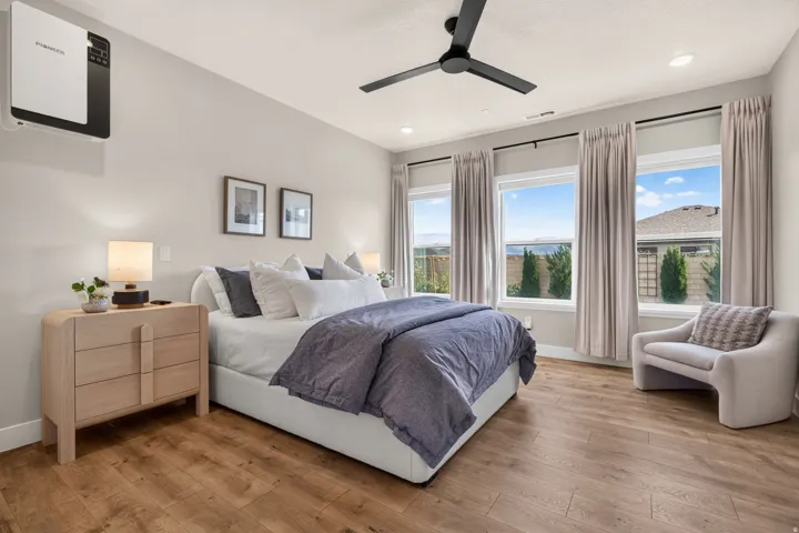 Wood-finish flooring, recessed lighting, and a ceiling fan with integrated lighting