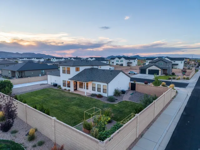 Expansive private yard featuring a manicured lawn, established plantings, and a dedicated garden area