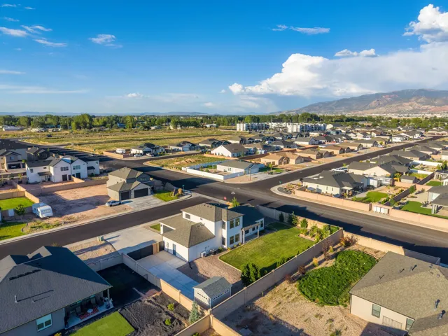 Aerial perspective of a residential neighborhood with a distant mountain range
