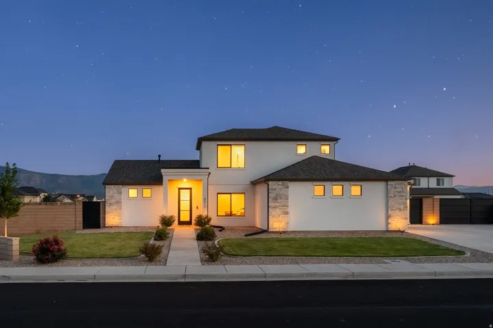 Modern two-story residence with white stucco and stone veneer accents