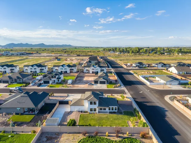 Newly constructed residential development featuring contemporary homes, paved streets, and landscaped yards