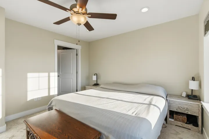 Recessed ceiling lighting, ceiling fan with integrated light fixture, light-colored carpeting, white trim, and a paneled interior door